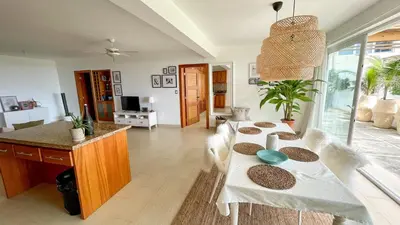 a living room with a table and a dog in it at Residencial Mañanero in Cabarete
