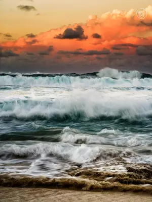 a beach with crashing waves and a sunset at Residencial Mañanero in Cabarete