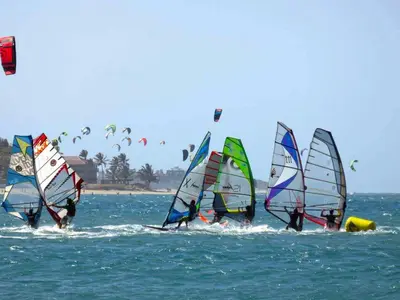 a group of people windsurfing in the ocean at Residencial Mañanero in Cabarete
