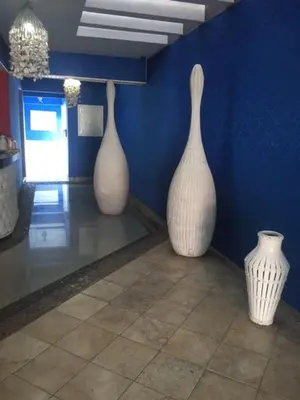 three white vases sitting on the floor in a room at Hotel Maracas Punta Cana in Punta Cana