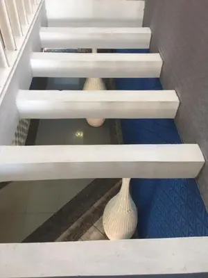 a stair case with two vases on the bottom shelf at Hotel Maracas Punta Cana in Punta Cana
