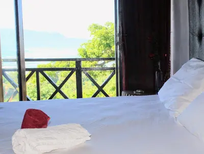 a bedroom with a bed with a view of the ocean at El Castillo in Las Galeras