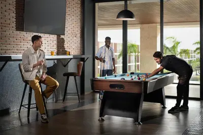 a group of men playing a game of billiard at Live Aqua Punta Cana - All Inclusive - Adults Only in Punta Cana