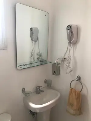 a bathroom with a sink and a mirror at Aprtamento Deluxe Santiago, Residencial Palma Real R402 in Santiago de los Caballeros