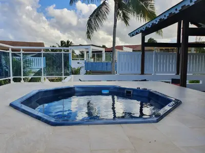 a large blue swimming pool on a patio at Palmeraie Terrenas Beach Apartment in Las Terrenas