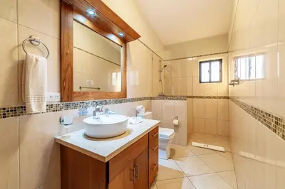 a bathroom with a sink and a toilet and a mirror at 883 Residencial Casa Linda in Sosúa