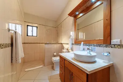 a bathroom with a sink and a toilet and a mirror at 883 Residencial Casa Linda in Sosúa