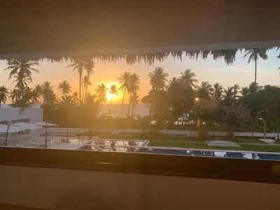 a view from a window of a resort with palm trees at Oasi Encantada - Beach Resort in Santa Cruz de Barahona