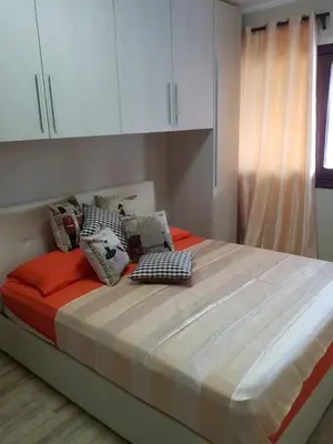 a large bed in a room with white cabinets at Oasi Encantada - Beach Resort in Santa Cruz de Barahona