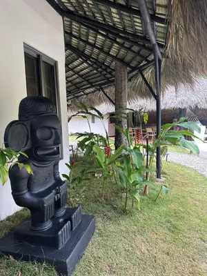 a statue in front of a building with plants at El Rincon de Abi in Las Terrenas