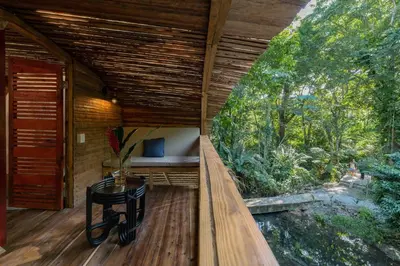 an outside view of a tree house with a bed and a table at El Valle Lodge in El Valle