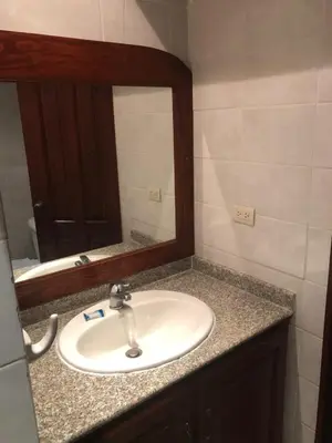 a bathroom with a sink and a mirror at Hotel Discovery in Santo Domingo