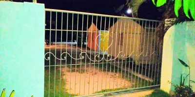 a gate with a bird inside of it at El Conde de Villa Rosa in Salado