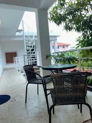 a patio with a glass table and two chairs at Villa Kate in Las Terrenas