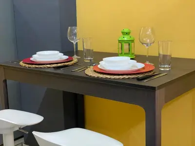 a table with plates and wine glasses on it at Apartahotel Guaraguao in San Pedro de Macorís