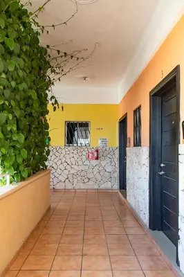 a hallway with a stone wall and a door at Apartahotel Guaraguao in San Pedro de Macorís