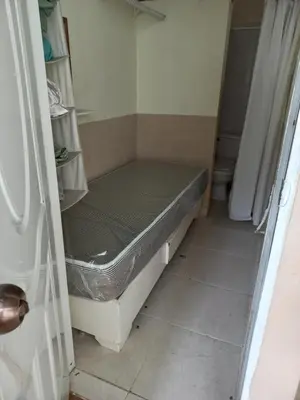 a small room with a bed in a bathroom at MiniHabitacion coqueta in Santo Domingo