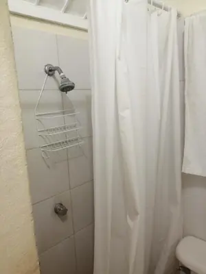 a bathroom with a shower with a shower curtain at MiniHabitacion coqueta in Santo Domingo