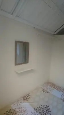 a bedroom with a bed and a mirror on the wall at MiniHabitacion coqueta in Santo Domingo