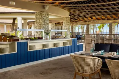 a restaurant with blue walls and tables and chairs at Wyndham Alltra Punta Cana All Inclusive Resort in Punta Cana