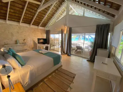 a bedroom with a large bed in a room at El Mosquito Boutique Hotel Playa Bonita in Las Terrenas