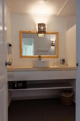 a bathroom with a sink and a mirror at El Mosquito Boutique Hotel Playa Bonita in Las Terrenas
