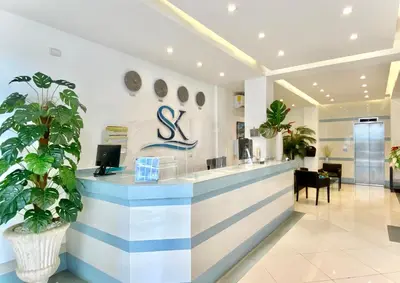 a lobby with a blue and white striped counter at Hotel Shakey in Santo Domingo