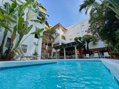 a swimming pool in front of a building at Hotel San Marco in Santo Domingo