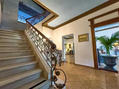 a staircase in a house with a plant in a vase at Hotel San Marco in Santo Domingo