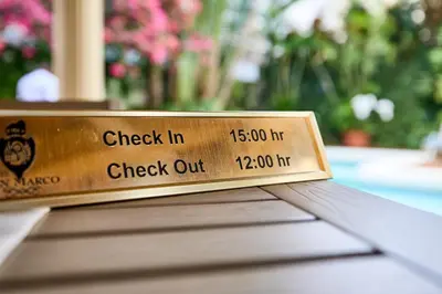 a wooden sign sitting on top of a table at Hotel San Marco in Santo Domingo