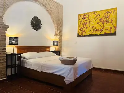 a bedroom with a bed with a basket on it at Paseo Colonial - El Monasterio #4 in Santo Domingo