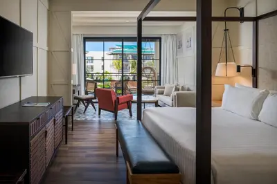 a hotel room with a bed and a living room at El Beso Adults Only At Ocean El Faro - All Inclusive in Punta Cana