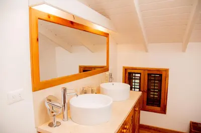 a bathroom with a sink and a mirror at Villa Flamboyan in Las Galeras