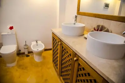 a bathroom with two sinks and a toilet at Villa Flamboyan in Las Galeras