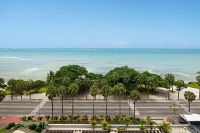 an aerial view of a parking lot and the ocean at Sheraton Santo Domingo in Santo Domingo