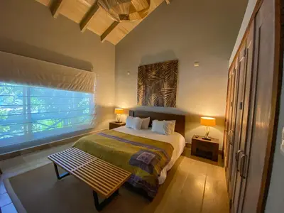 a bedroom with a large bed and a window at Xeliter Balcones del Atlantico - Las Terrenas in Las Terrenas