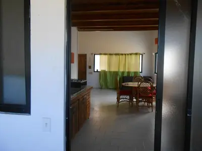 a kitchen and dining room with a table and chairs at 22 plaza rosada in Las Terrenas