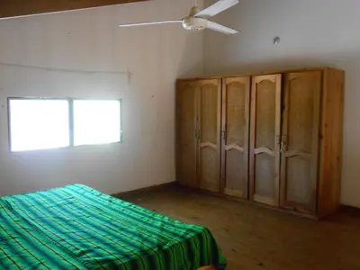 a bedroom with a bed and a ceiling fan at 22 plaza rosada in Las Terrenas