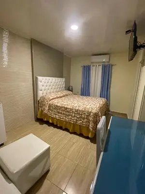 a small room with a bed and a table at Hotel Frano Romana Center in La Romana