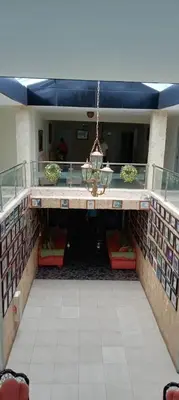 a building with a balcony with a table and chairs at Hotel Frano Romana Center in La Romana
