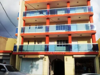 a building with blue and orange balconies on it at Hotel Boutique River View La Romana in La Romana