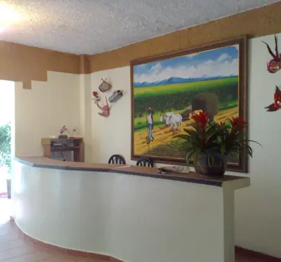 a lobby with a painting on the wall at Hotel Boutique River View La Romana in La Romana
