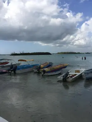 a group of boats sitting in the water at TERRAZAS DEL CARIBE, APARTA HOTEL. in Santo Domingo