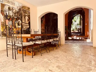 a room with chairs and paintings on the wall at Paseo Colonial - Sanctuary #2 in Santo Domingo