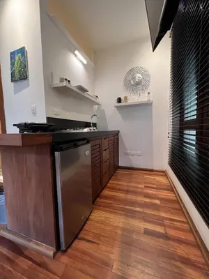 a kitchen with a stainless steel refrigerator and wooden floors at Paseo Colonial - Leo's Favorite #8 in Santo Domingo
