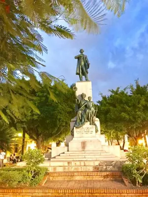 a statue of two men sitting on top of a monument at Paseo Colonial - Leo's Favorite #8 in Santo Domingo