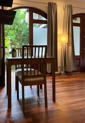 a wooden chair sitting at a table with a lamp at Paseo Colonial - Leo's Favorite #8 in Santo Domingo