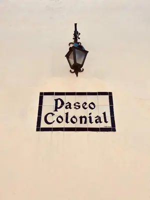 a sign on the side of a building with a street light at Paseo Colonial - Ermitage #5 in Santo Domingo