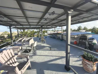a patio with chairs and a table and water at Hostel Eco Punta Cana in Punta Cana