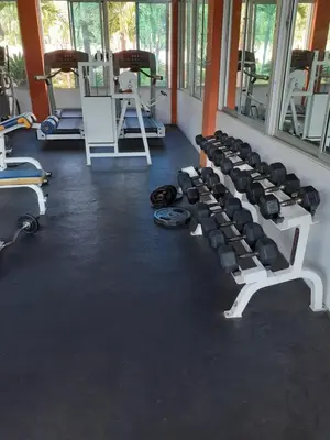 a gym with a bunch of equipment in a room at SANTIAGO CITY in Santiago de los Caballeros